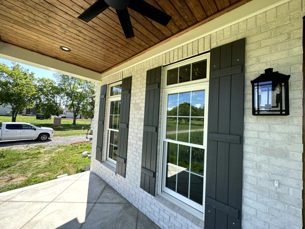 House exterior - white brick wall with two vertical windows