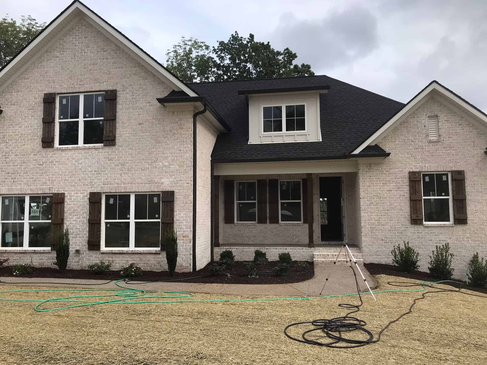 House exterior - Modern brick house with the lawn in the foreground