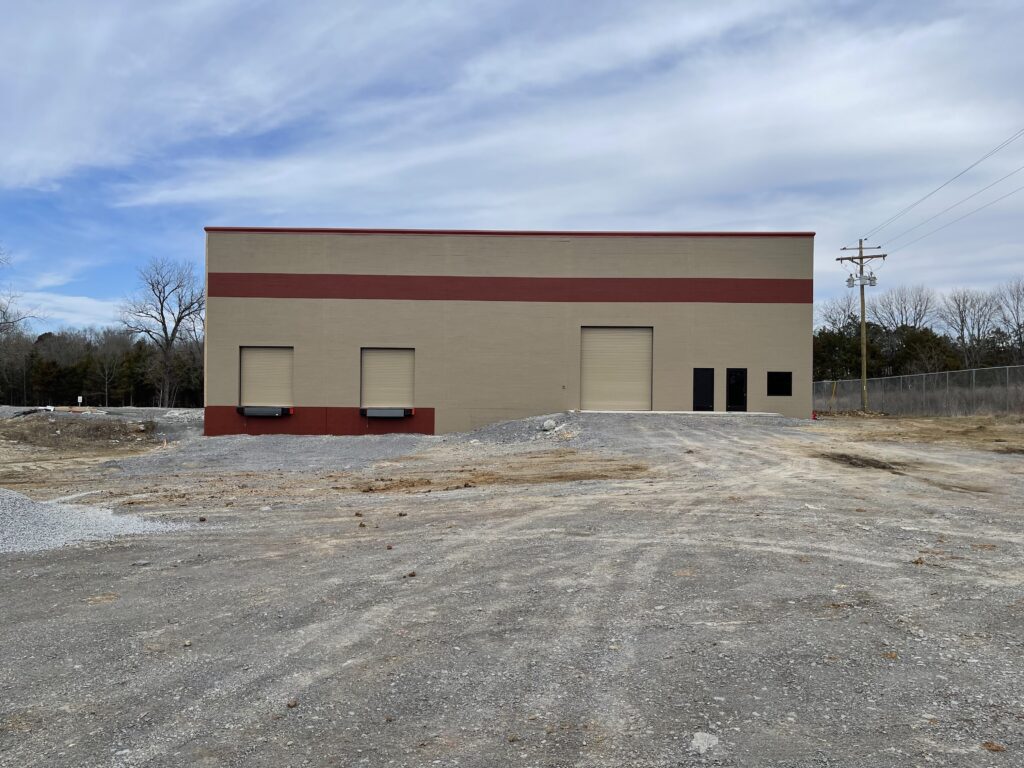 Newly painted single-floor building within an empty lot